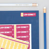 Sample University Label Pack On Notebook With Pencils